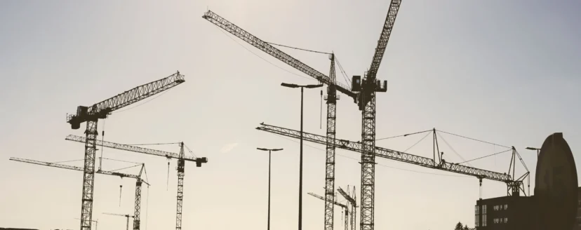 low-angle-shot-of-construction-cranes-against-a-pa-2026-01-07-23-16-10-utc