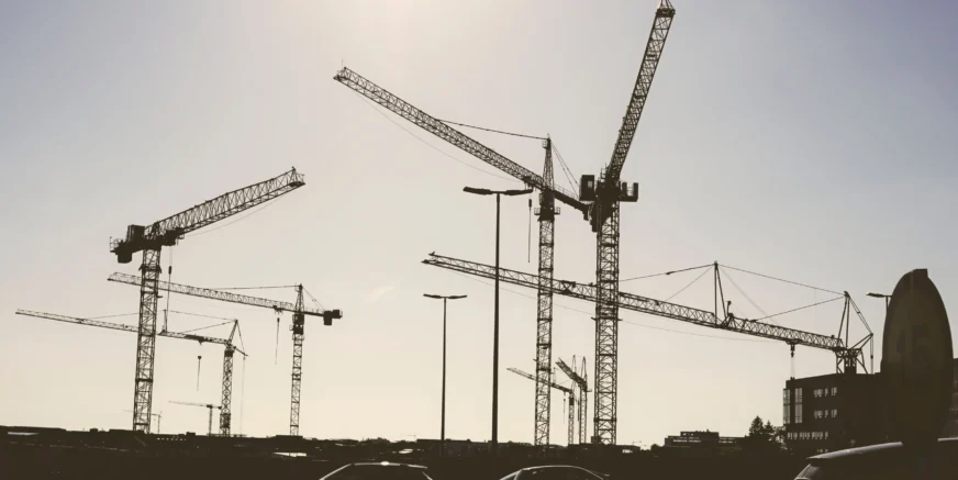 low-angle-shot-of-construction-cranes-against-a-pa-2026-01-07-23-16-10-utc