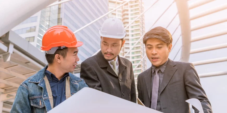 manager-meeting-with-engineer-outdoor-site-discuss-plan-looking-blueprint